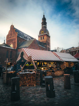 an outdoor market with a red and white awning