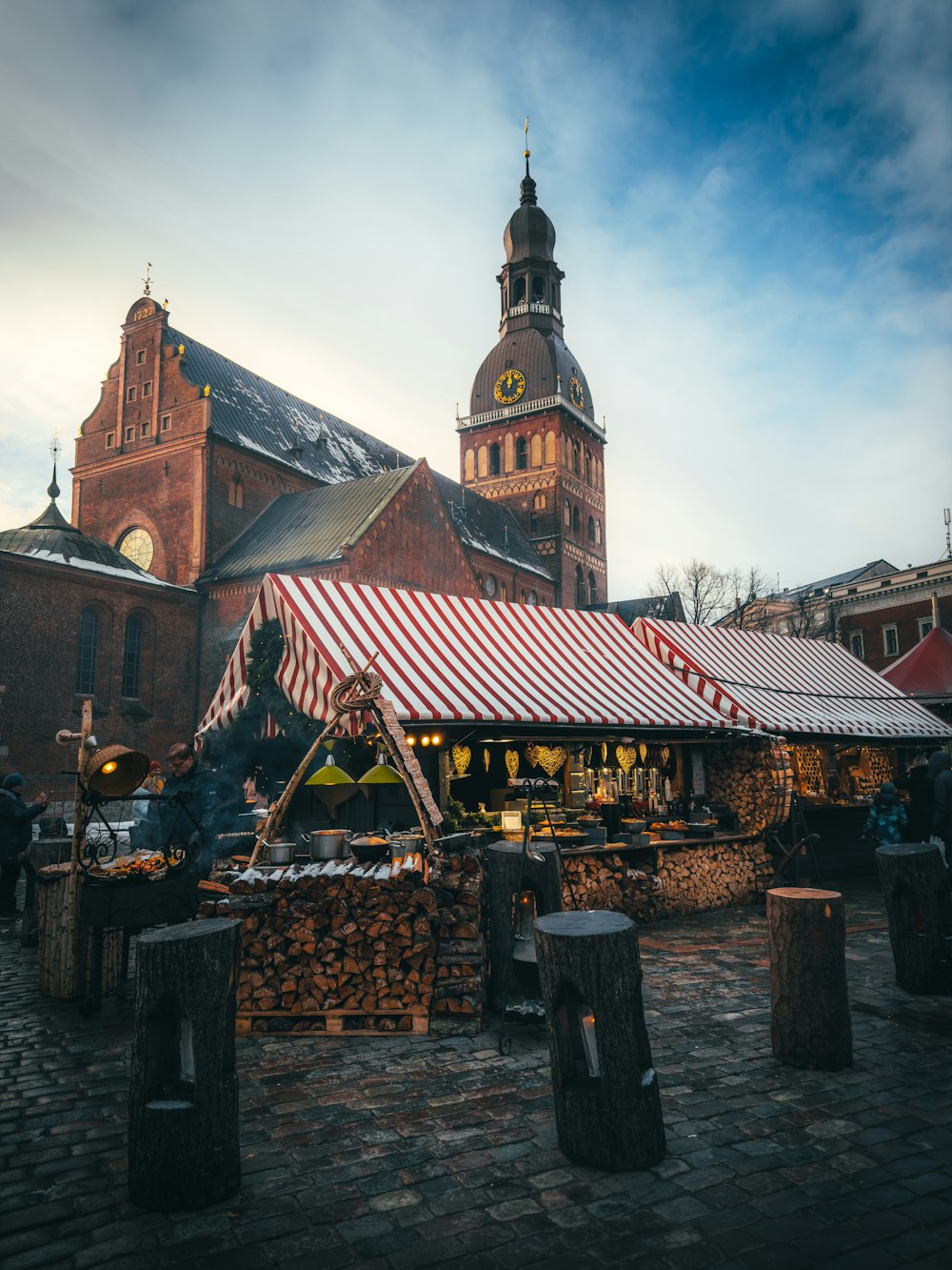an outdoor market with a red and white awning