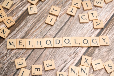 scrabble tiles spelling the word method on a wooden surface