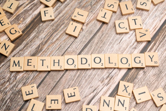 scrabble tiles spelling the word method on a wooden surface