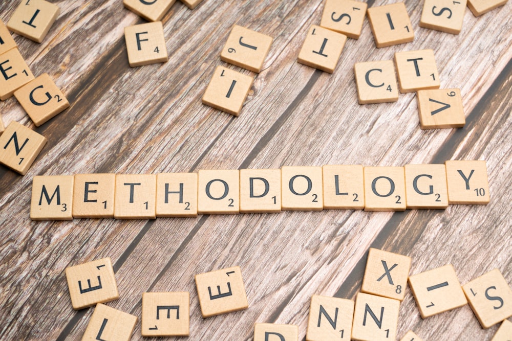 scrabble tiles spelling the word method on a wooden surface