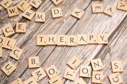 scrabbled scrabble tiles spelling the word therapy
