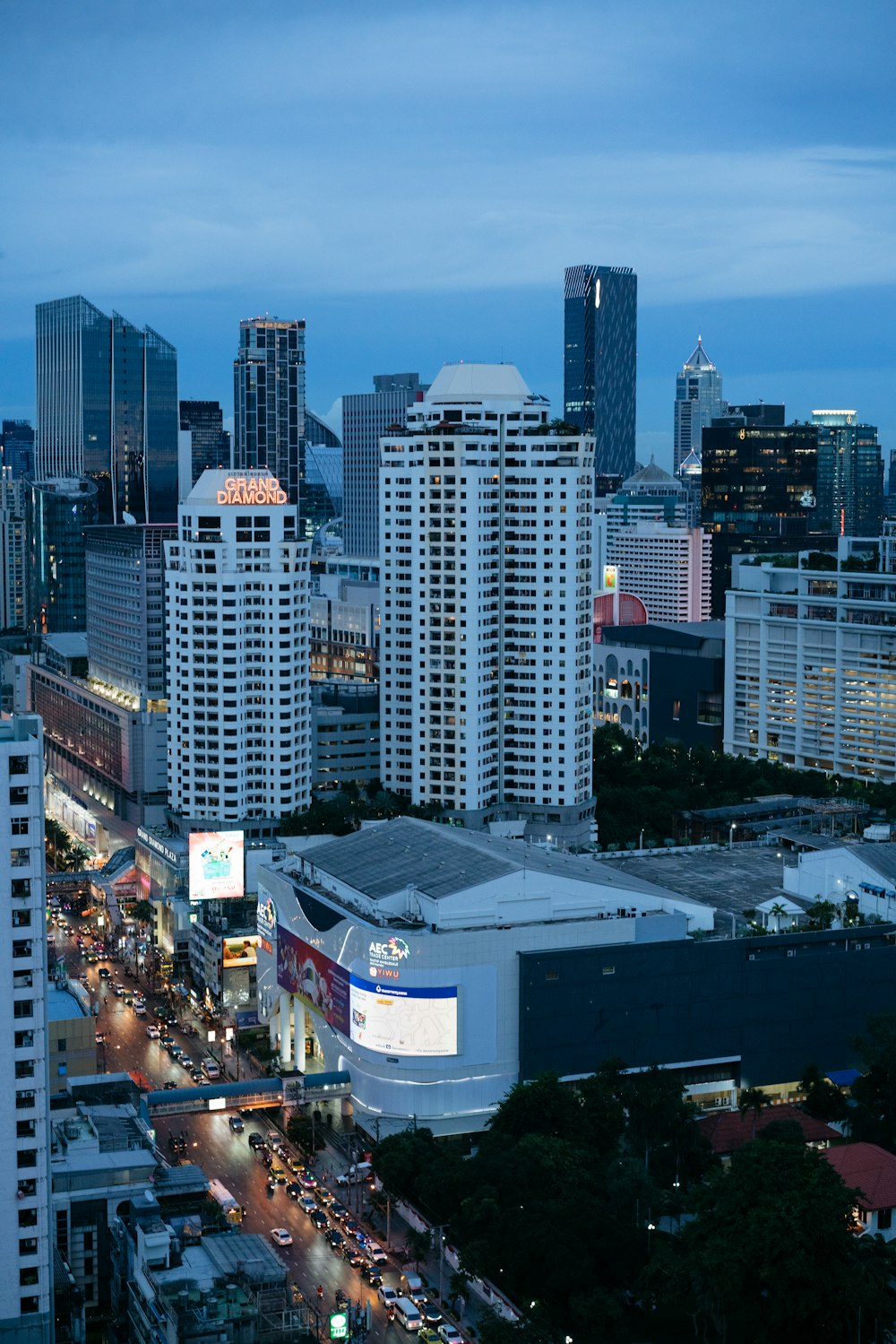 a view of a city at night with tall buildings