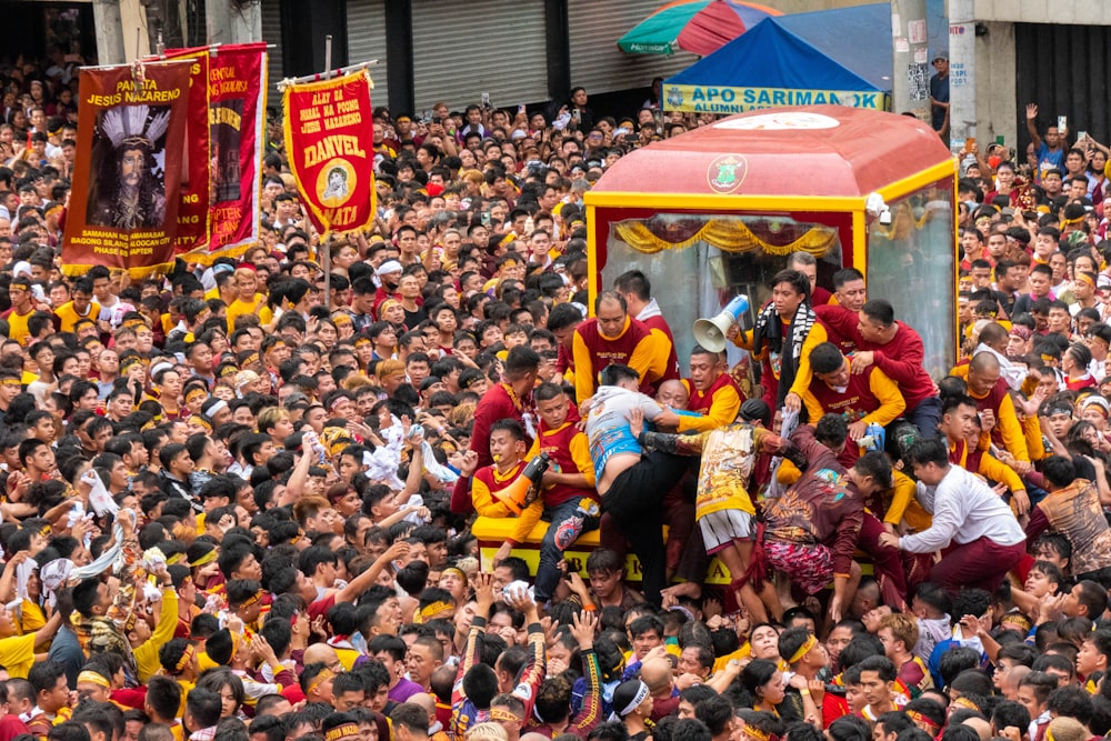 a group of people standing around a red and yellow truck