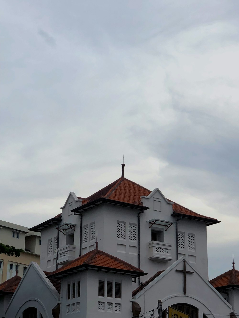 a large white building with a cross on top of it