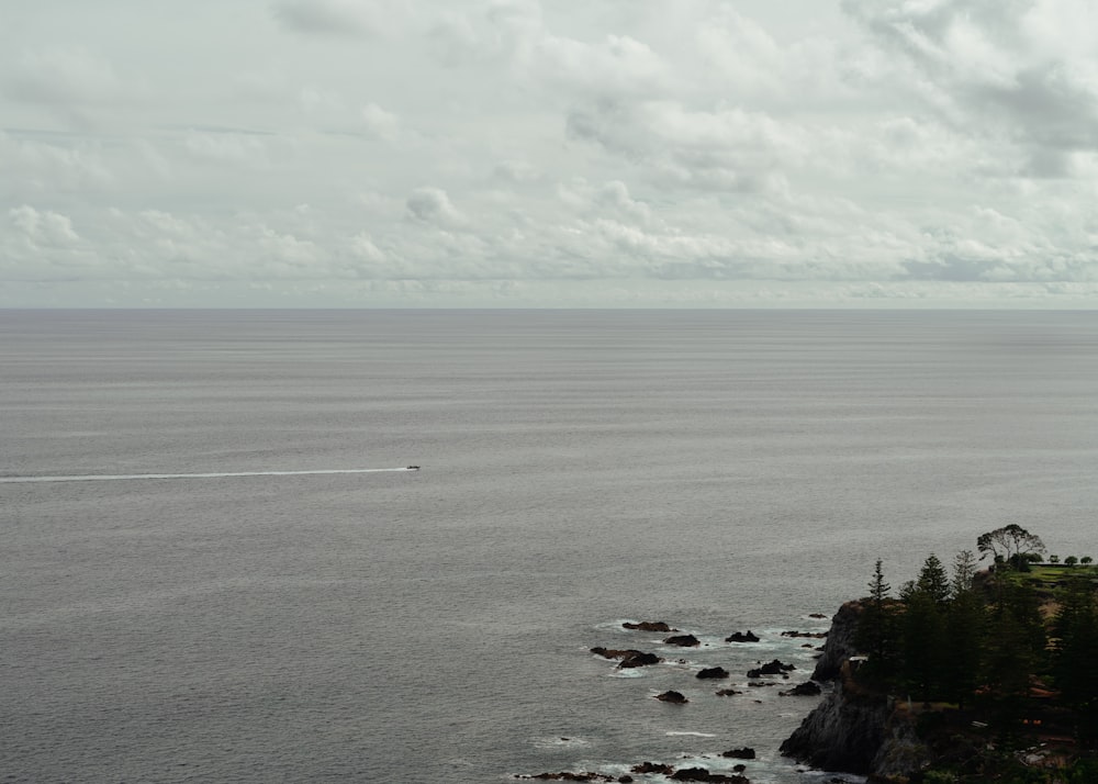 a boat is out on the water near the shore