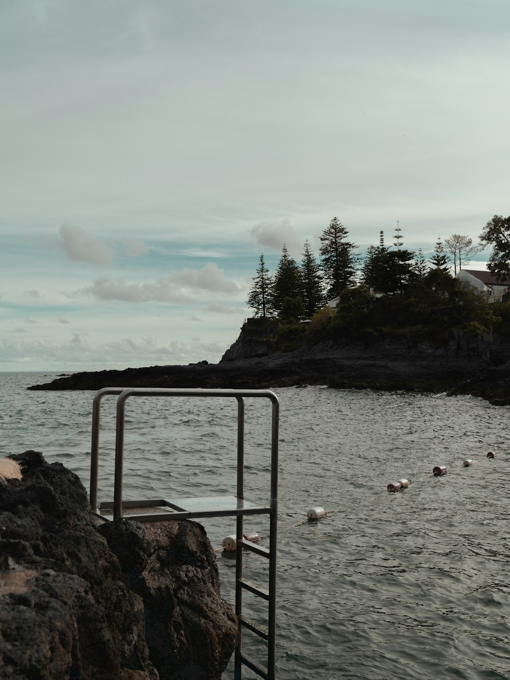 a view of a body of water with a lighthouse in the background