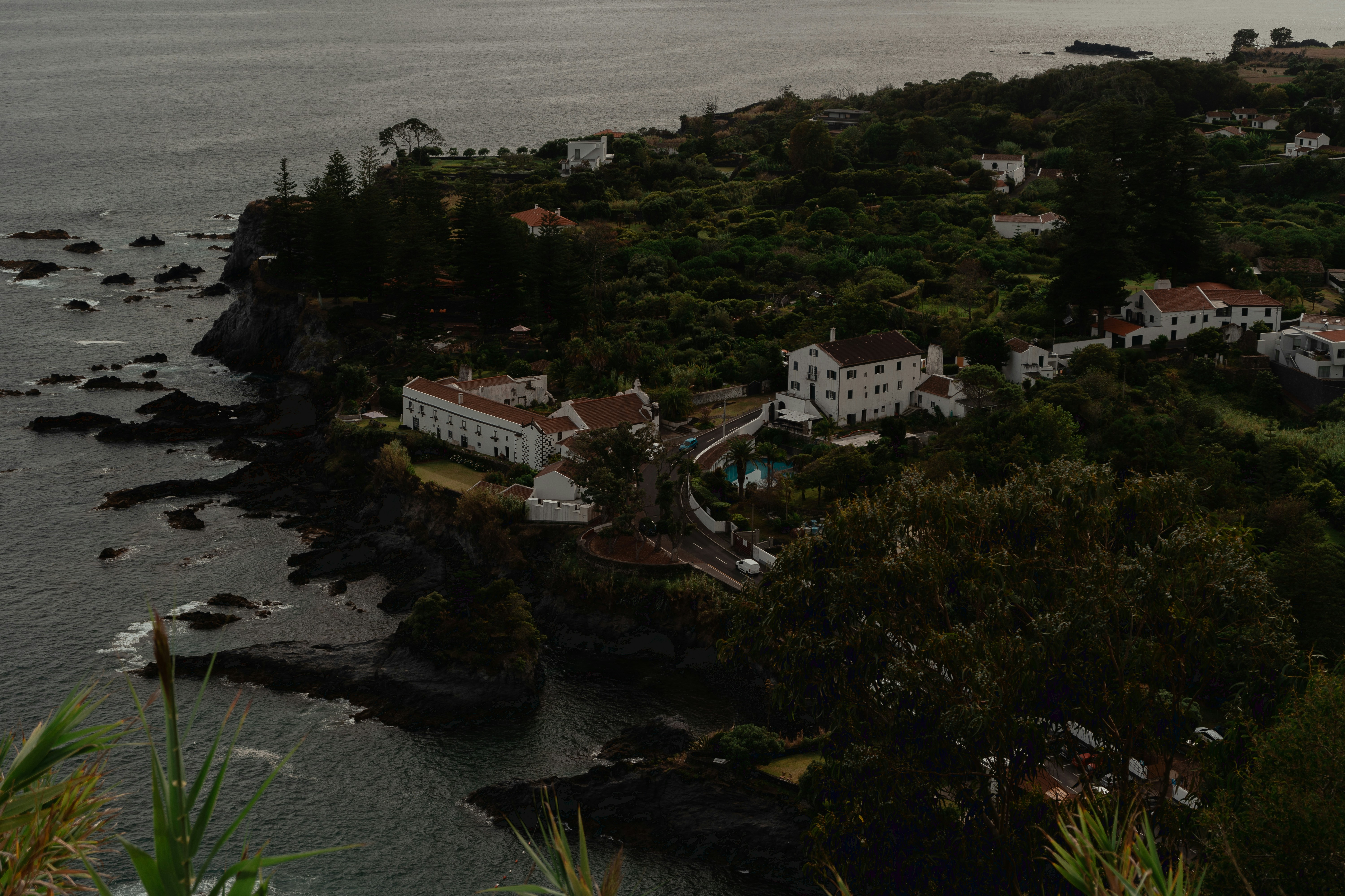 an aerial view of a small town on the coast, View of the town Água de Pau belonging to the municipality of Lagoa, located on the Island of São Miguel, Autonomous Region of Azores.