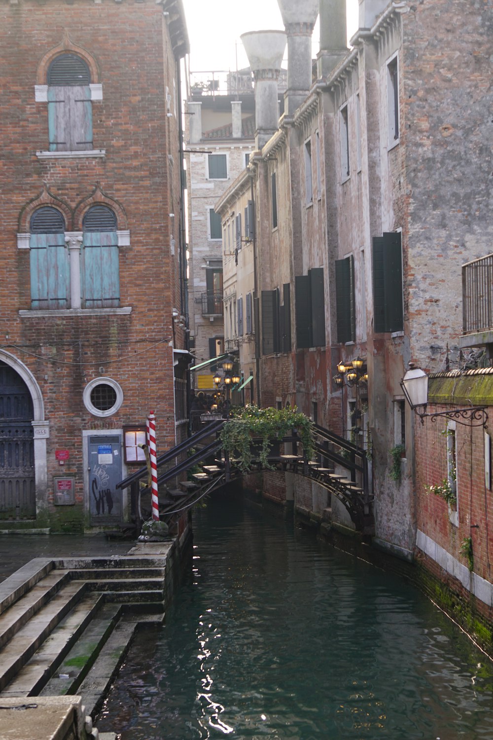 a canal running through a city next to tall buildings