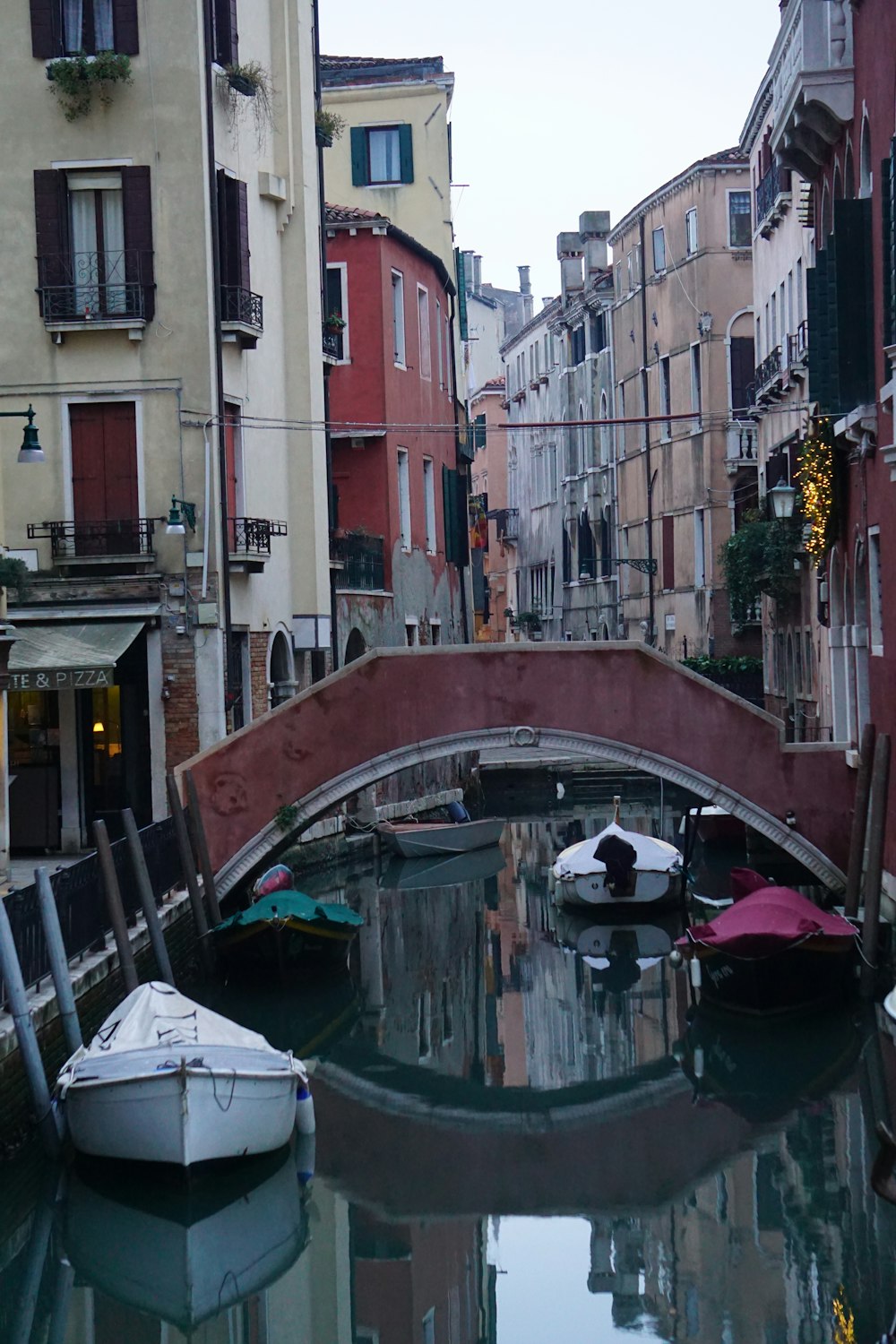 a small bridge over a small canal in a city