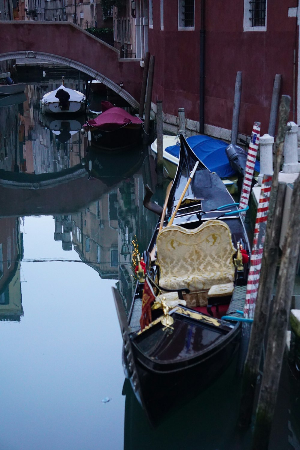 a gondola in a canal with a bridge in the background