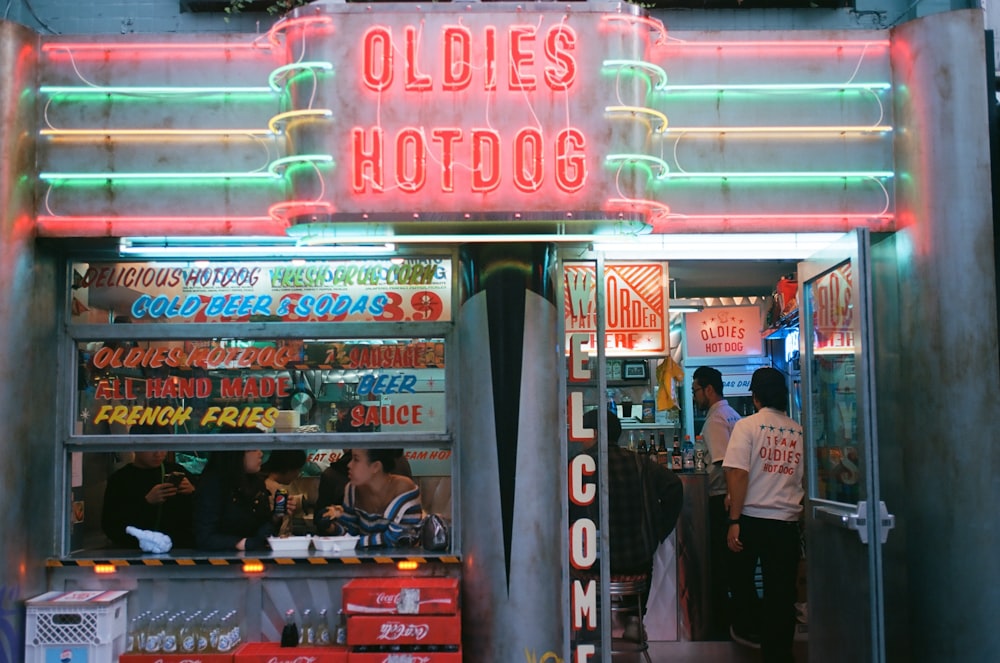 a neon sign that reads oldies hot dog