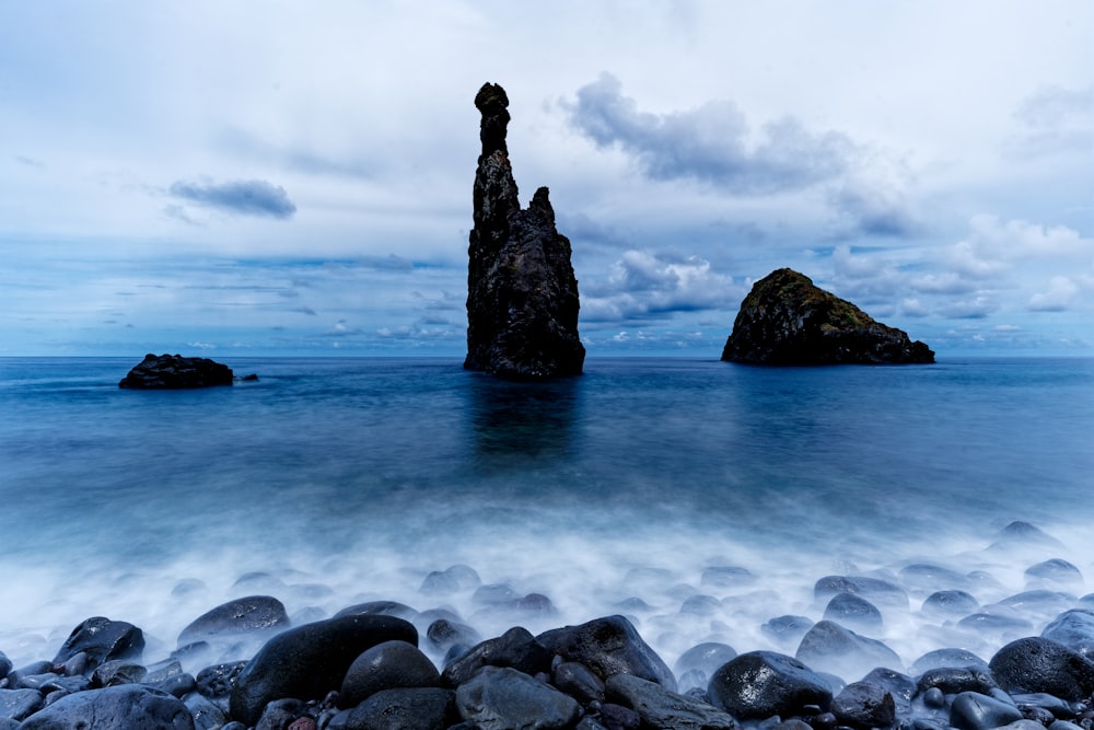 a large rock sticking out of the ocean