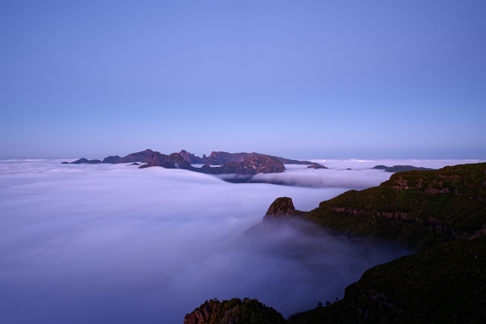 a view of a mountain covered in clouds