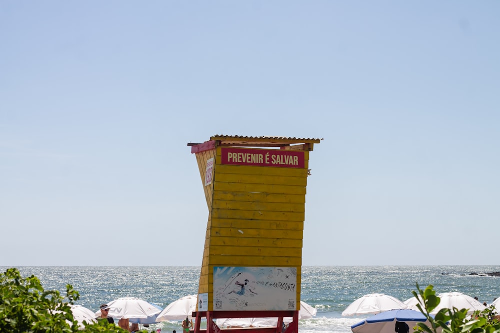 a lifeguard chair sitting on the beach next to the ocean