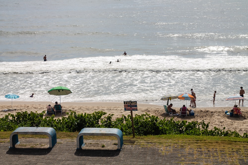 a group of people standing on top of a sandy beach