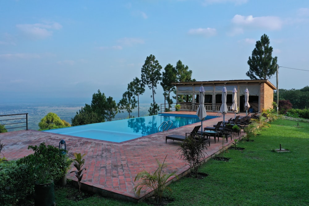 a large swimming pool in the middle of a lush green field