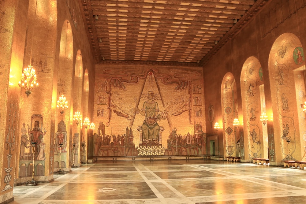 a large room with a statue and chandeliers