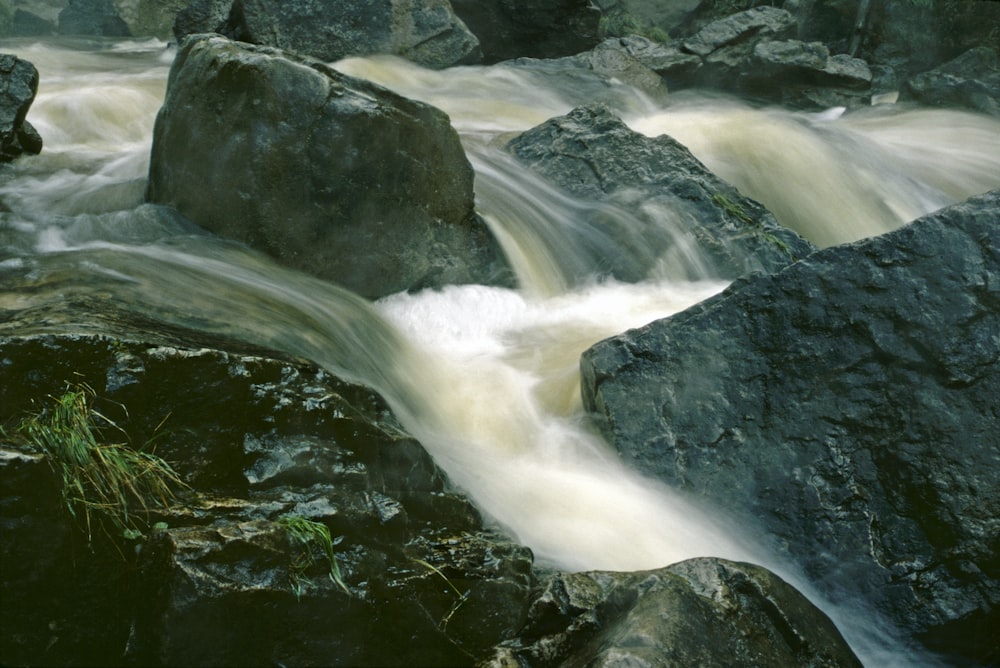 a stream of water running between large rocks