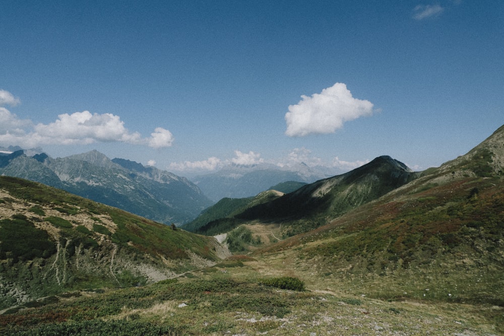 a view of a valley with mountains in the background