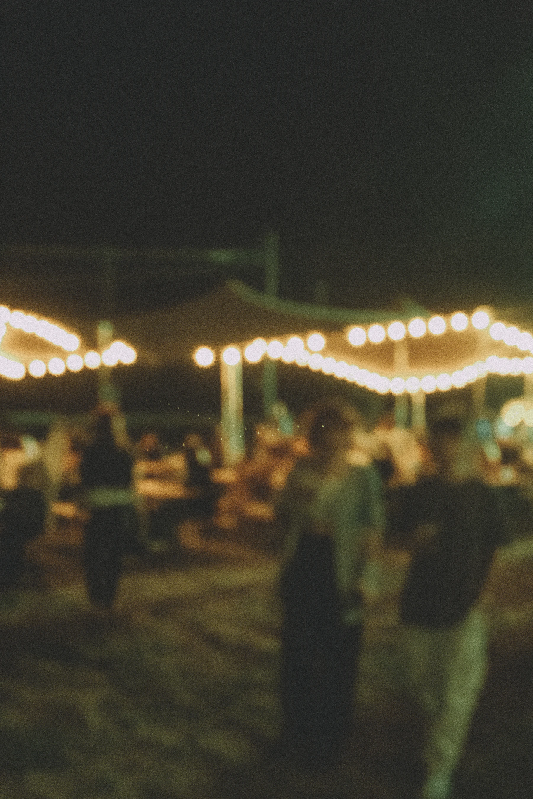Guests celebrating together late in the evening under warm light