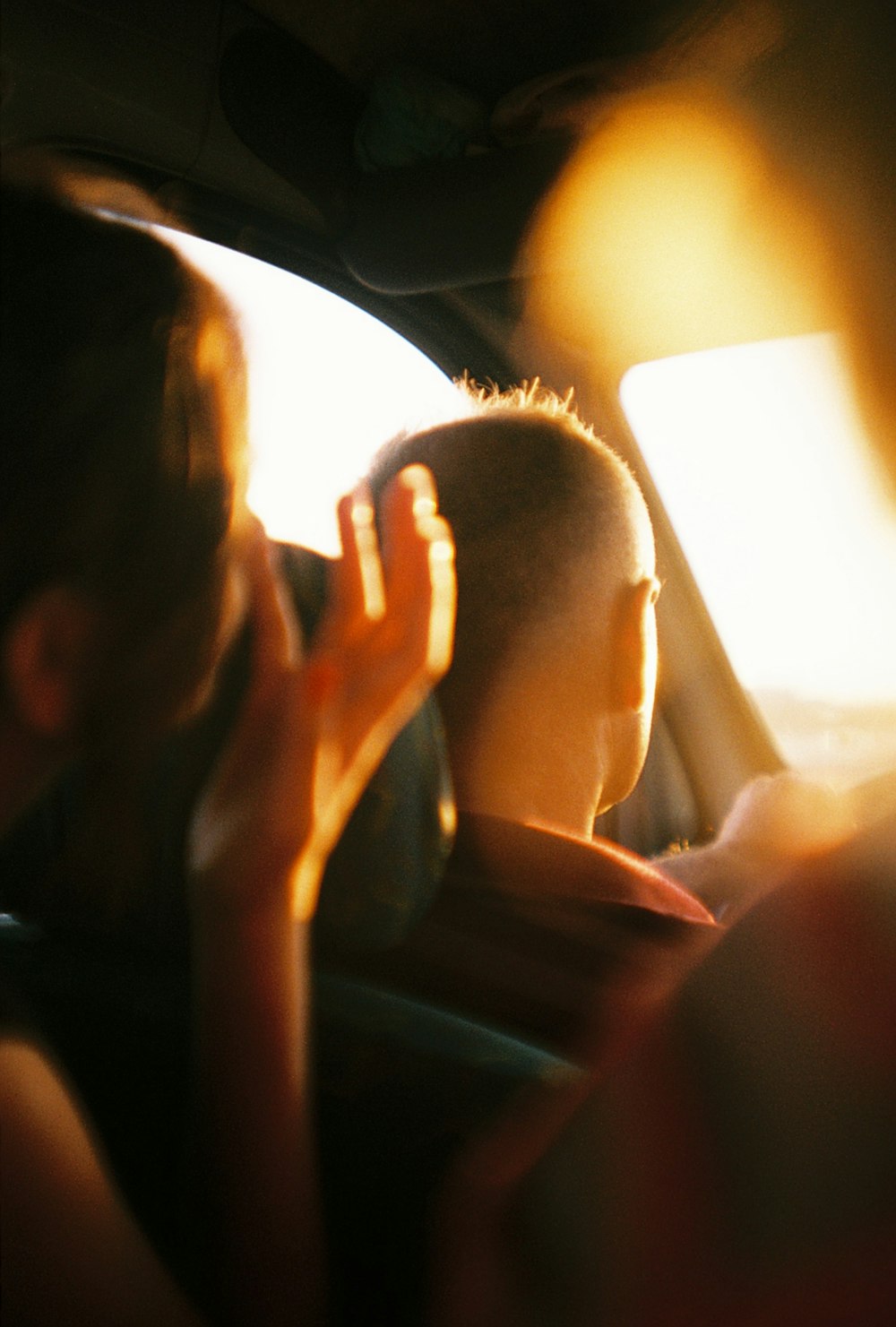 a person sitting in a car with a cell phone in their hand