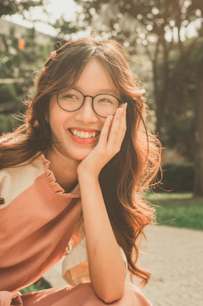 a woman wearing glasses sitting on a bench