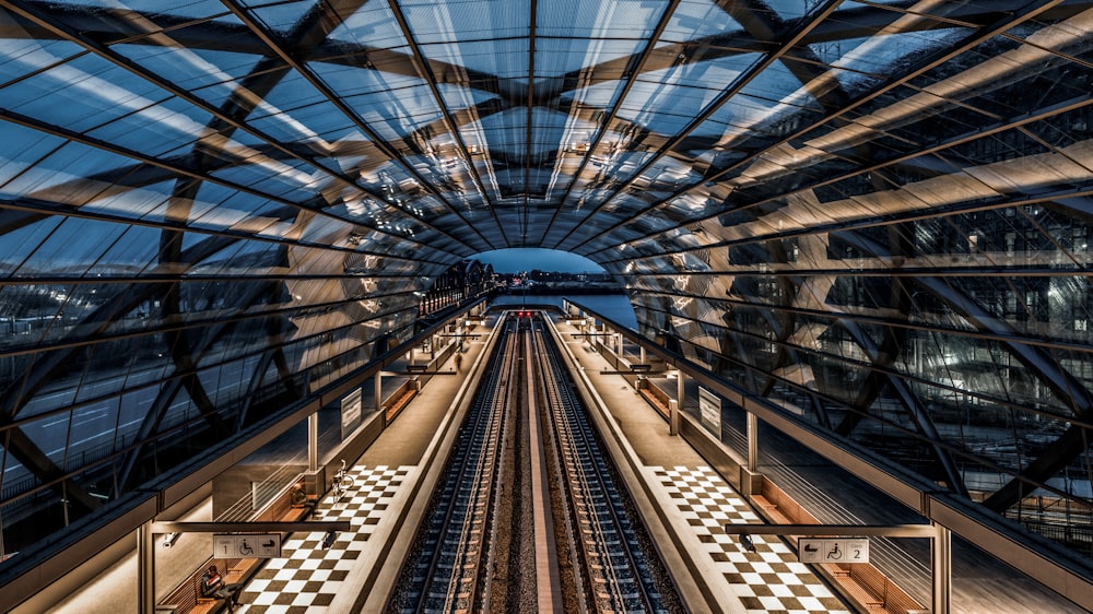 an overhead view of a train station with a checkered floor