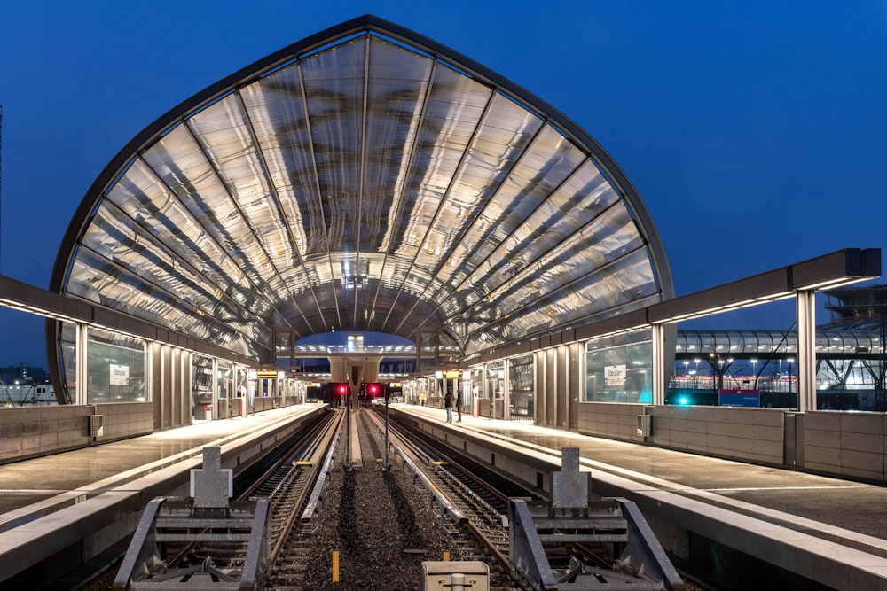 a train station with a train on the tracks