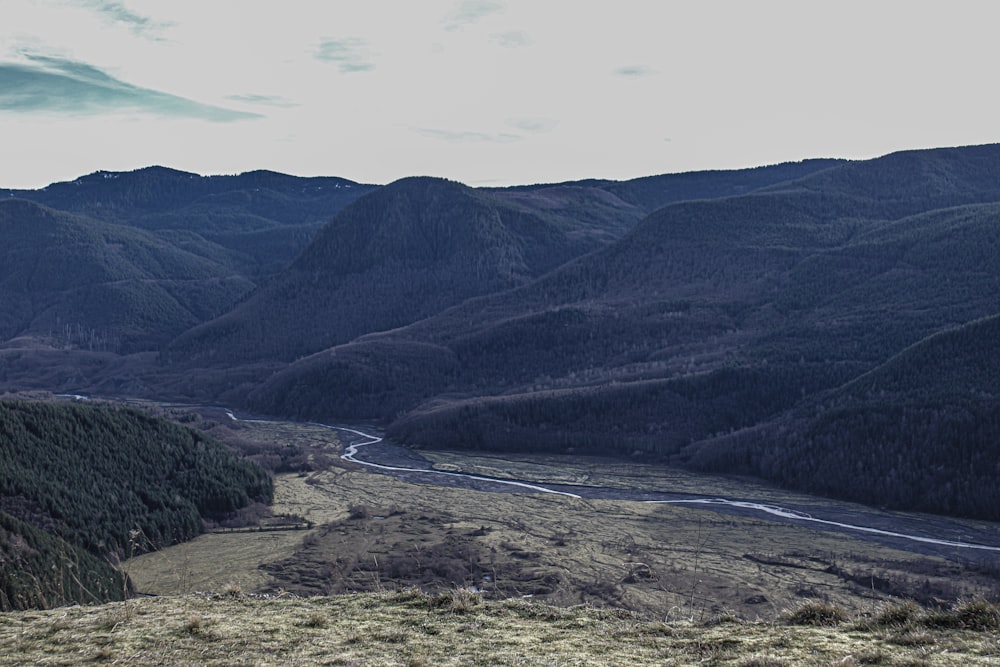 a view of a valley with a river running through it