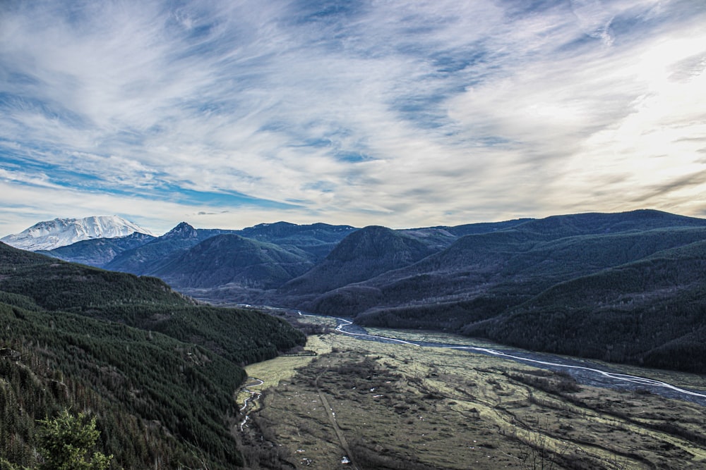 a view of a valley with a river running through it