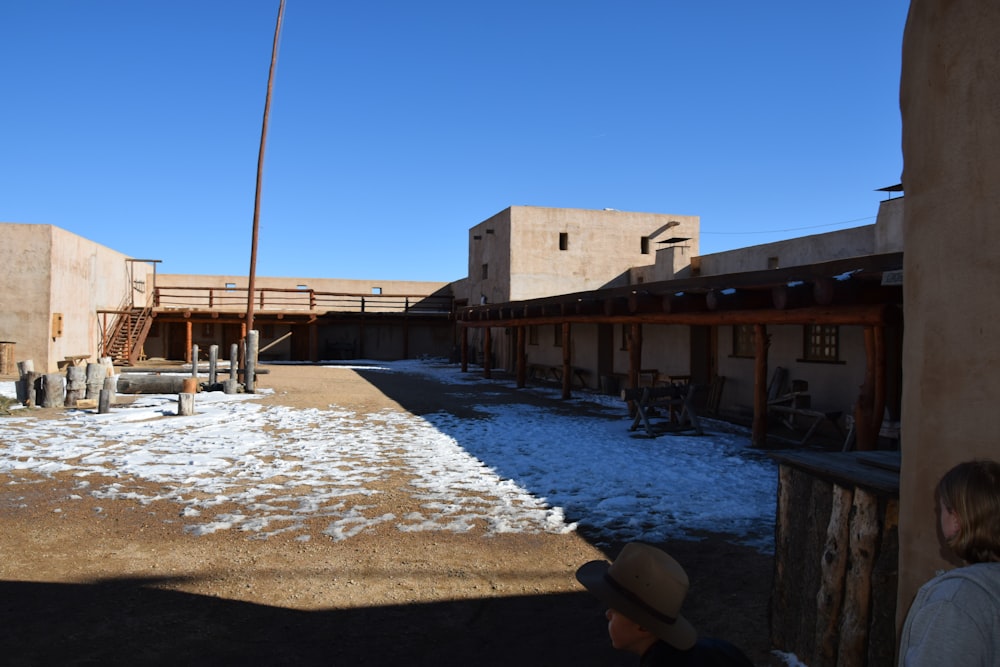 a person standing outside of a building with snow on the ground