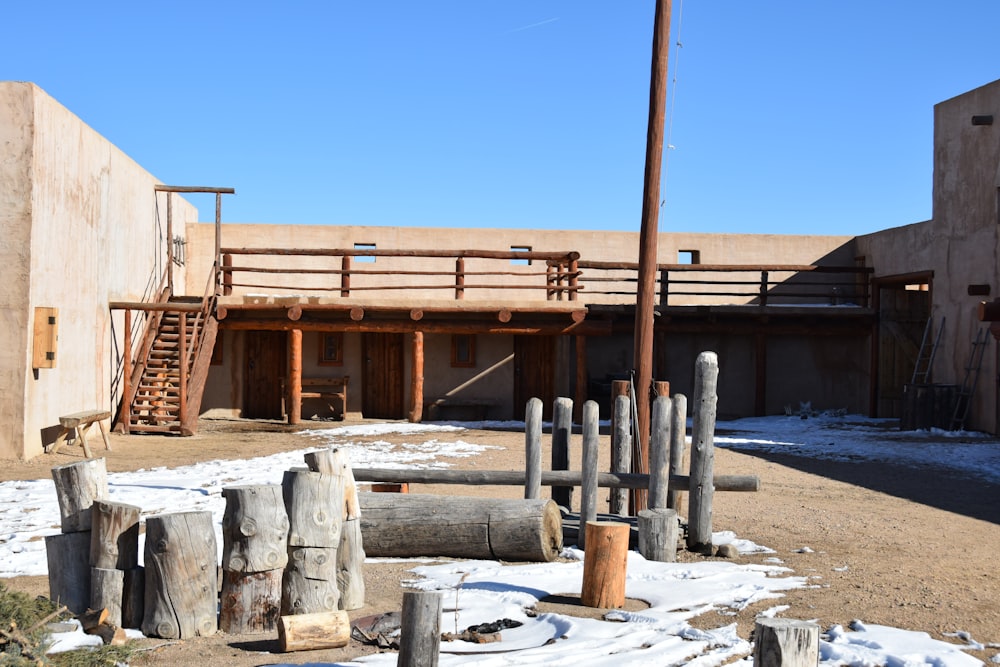 a building that has a bunch of logs in front of it