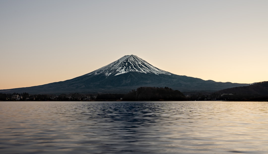 a mountain with a snow covered peak in the distance,