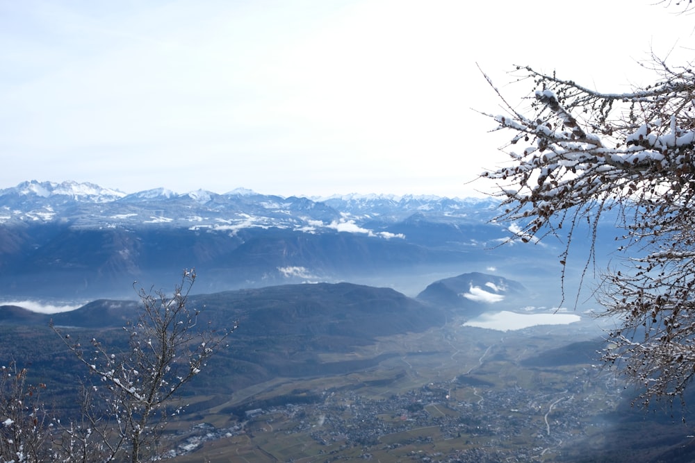 a view of a mountain range with a lake in the foreground