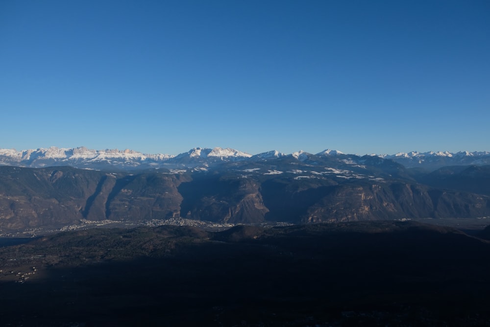 a view of a mountain range with snow capped mountains in the distance