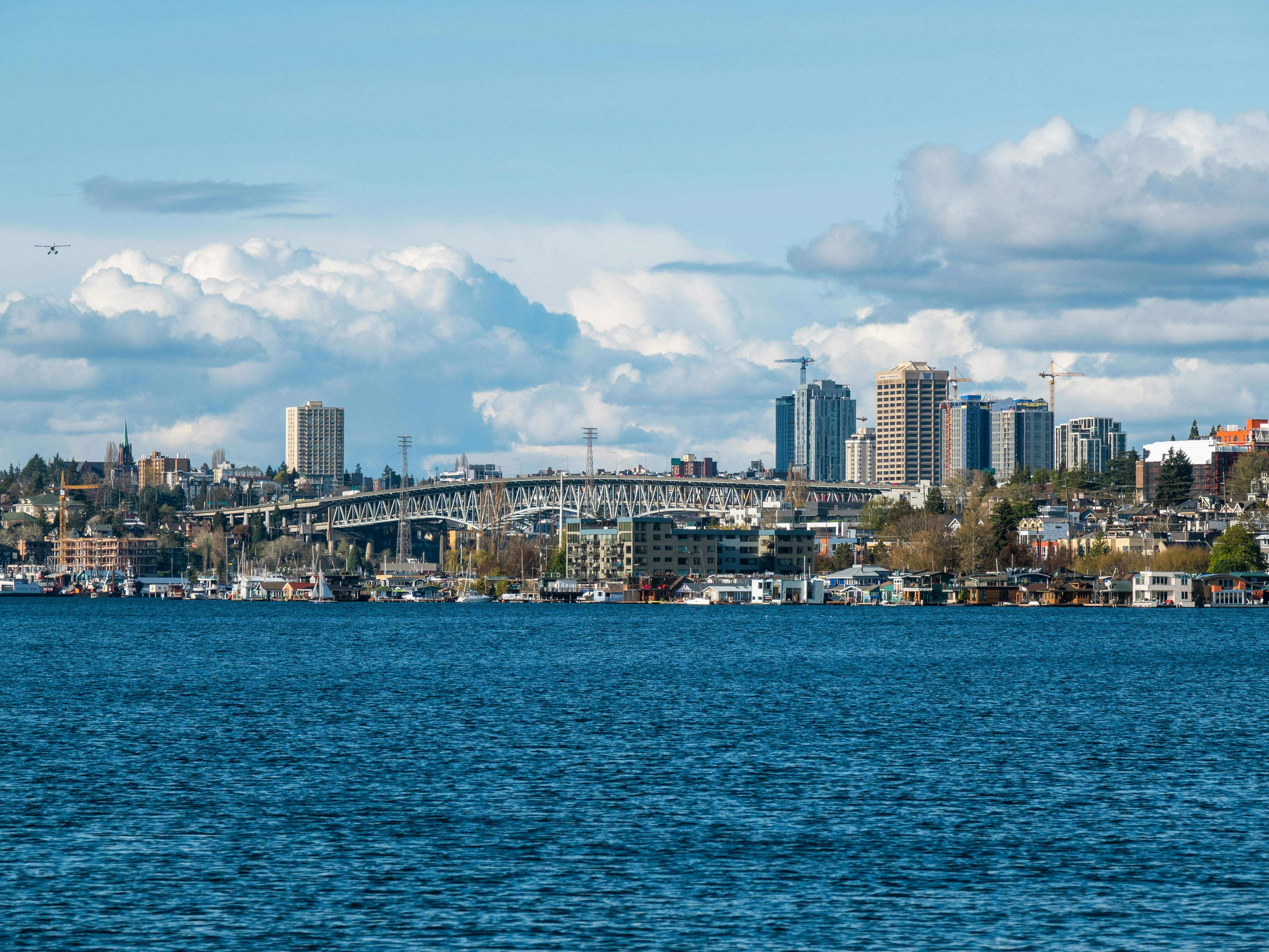 a large body of water with a city in the background, 