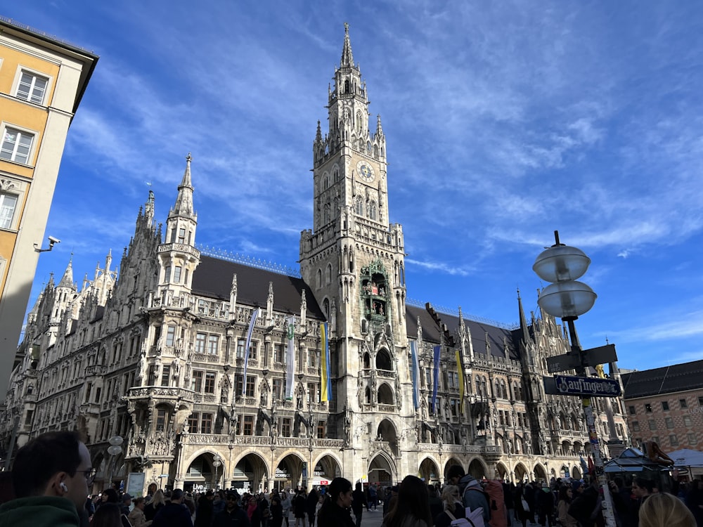 a group of people standing in front of a large building