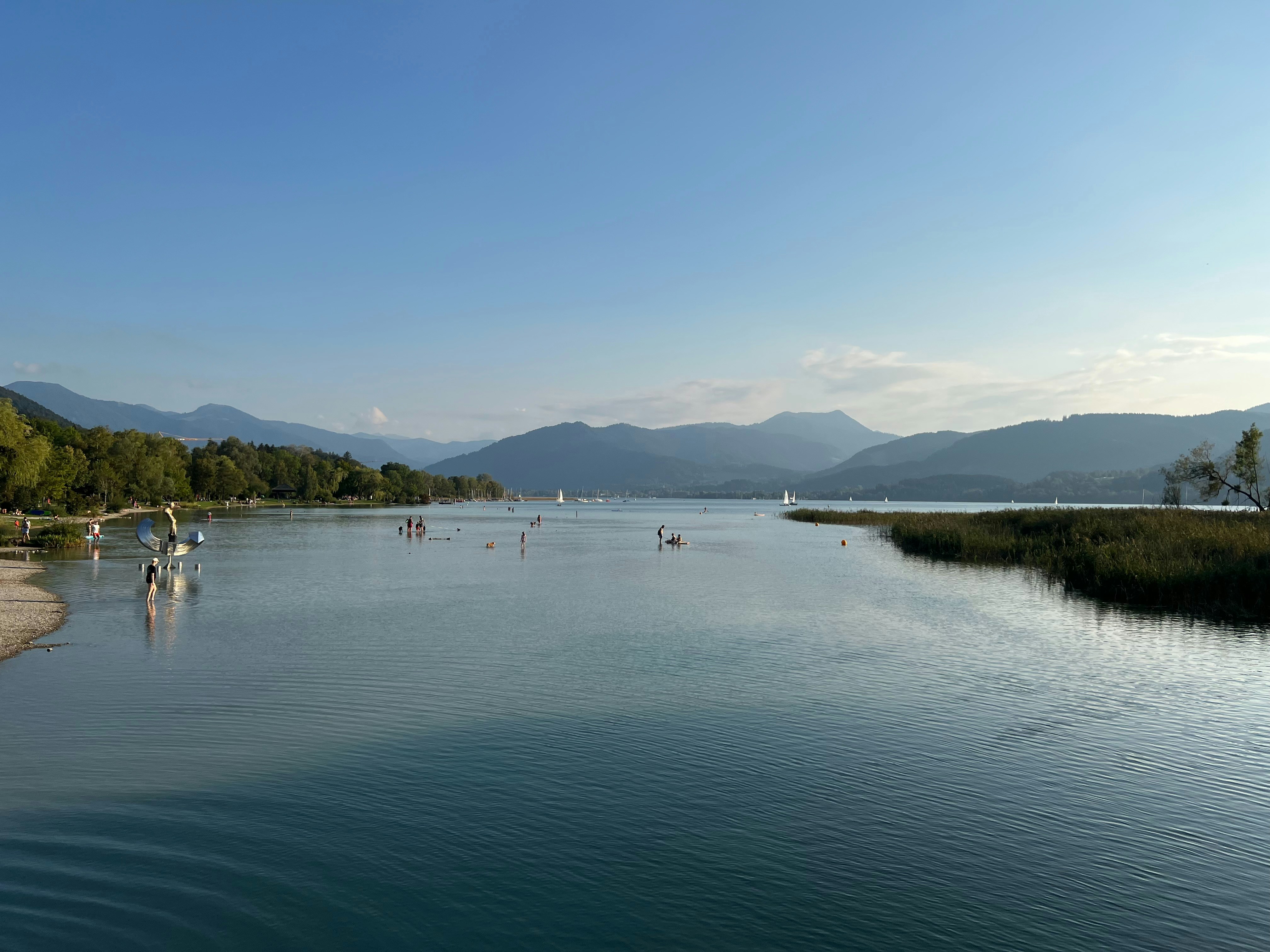 a body of water surrounded by mountains and trees
