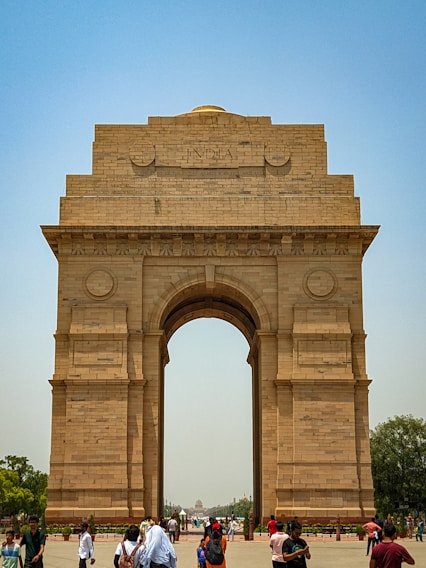 a group of people standing in front of a stone arch