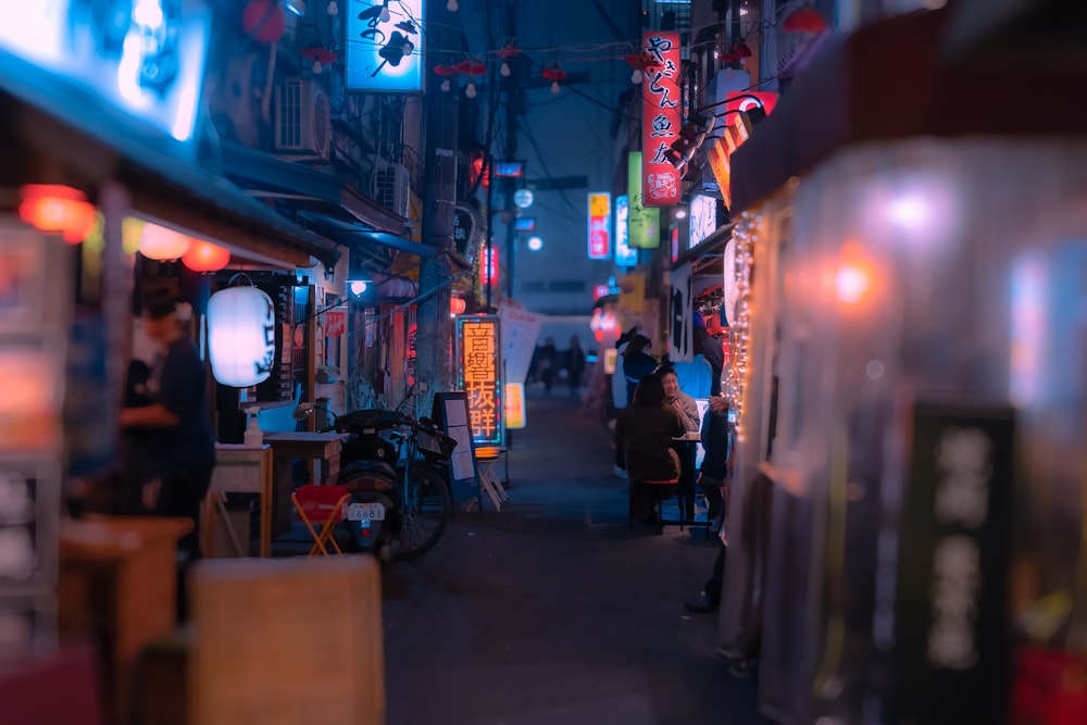 a narrow alley way with people walking down it