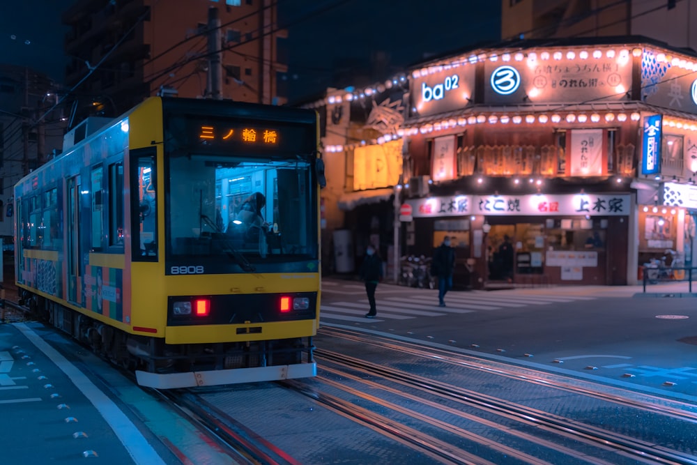 a train on a track in front of a building