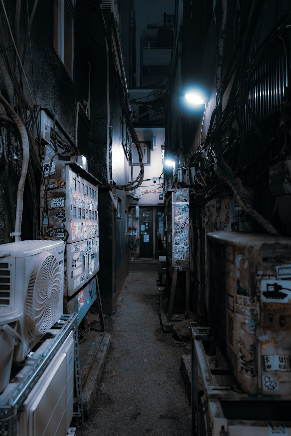 a dark alley with a bunch of old appliances