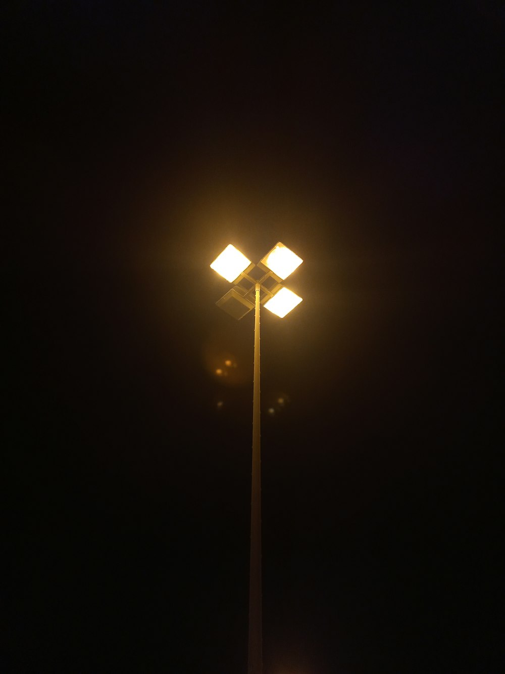 a street light in the dark on a dark night