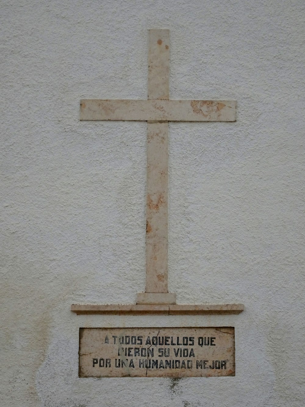 a cross on the side of a building