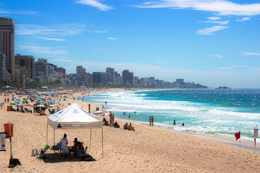 a crowded beach with many people on it