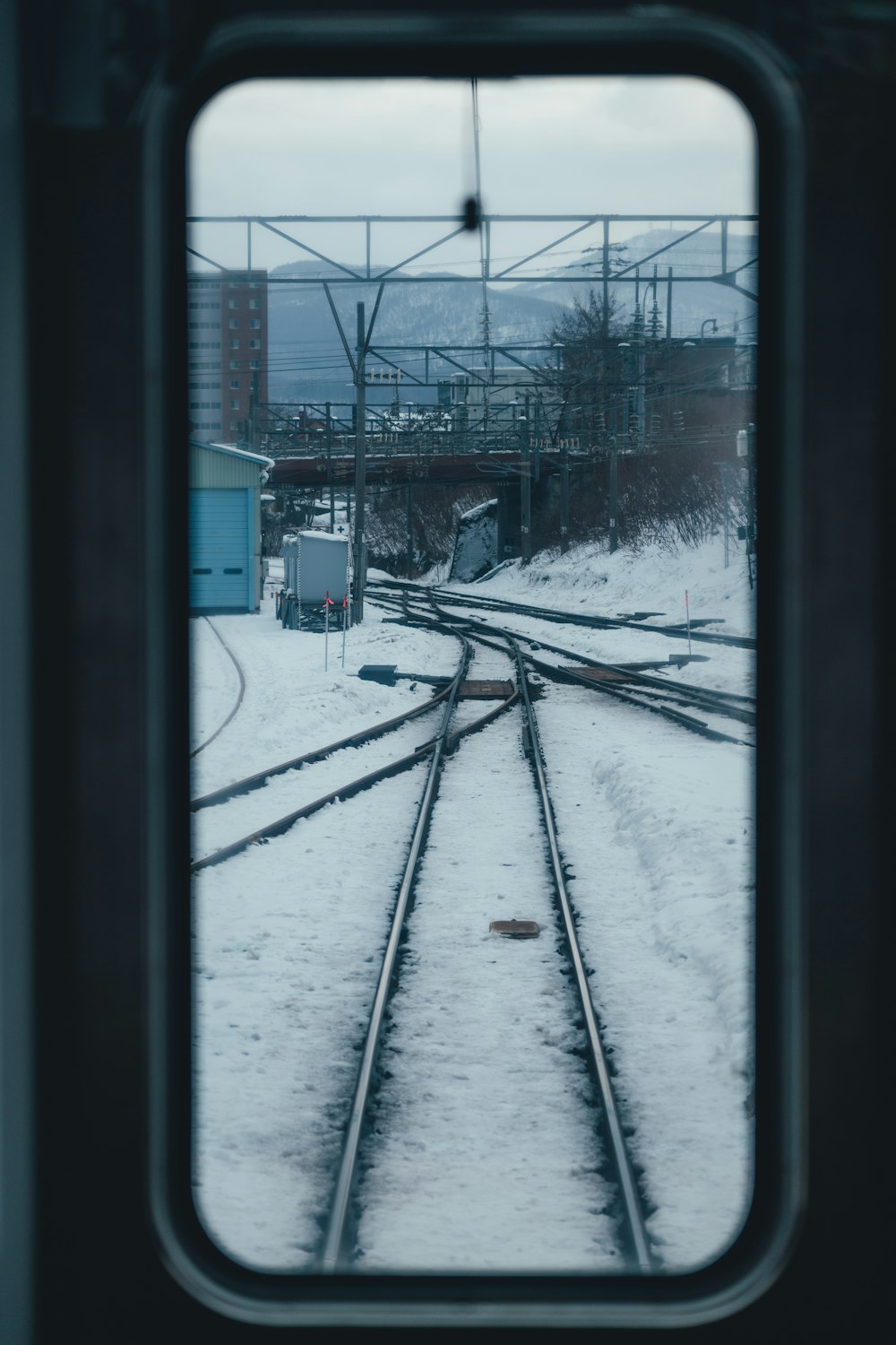 a view of a train track through a window