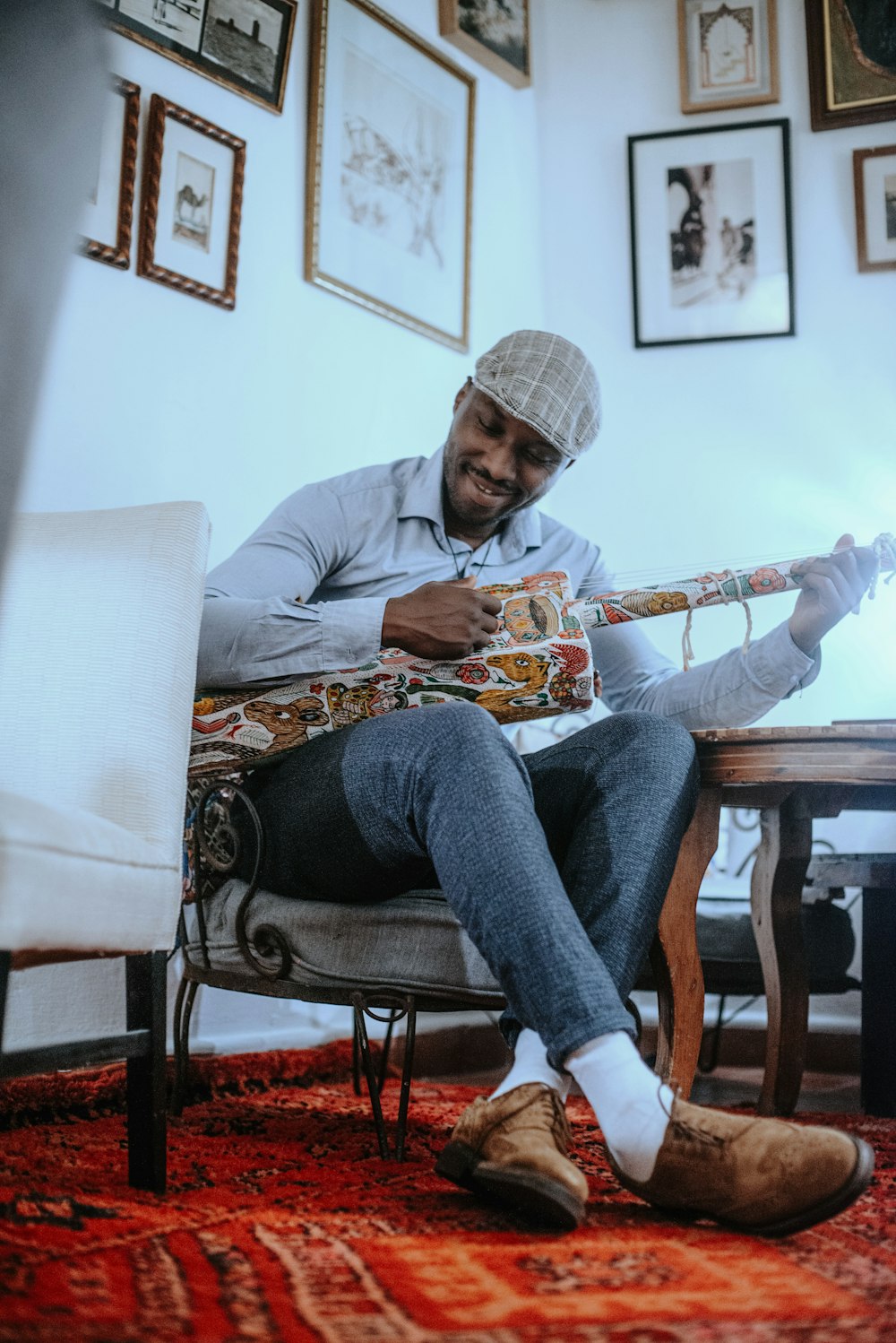 a man sitting in a chair with a guitar