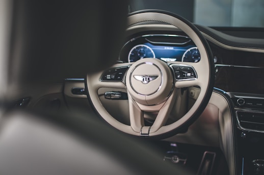 the interior of a car with a steering wheel and dashboard