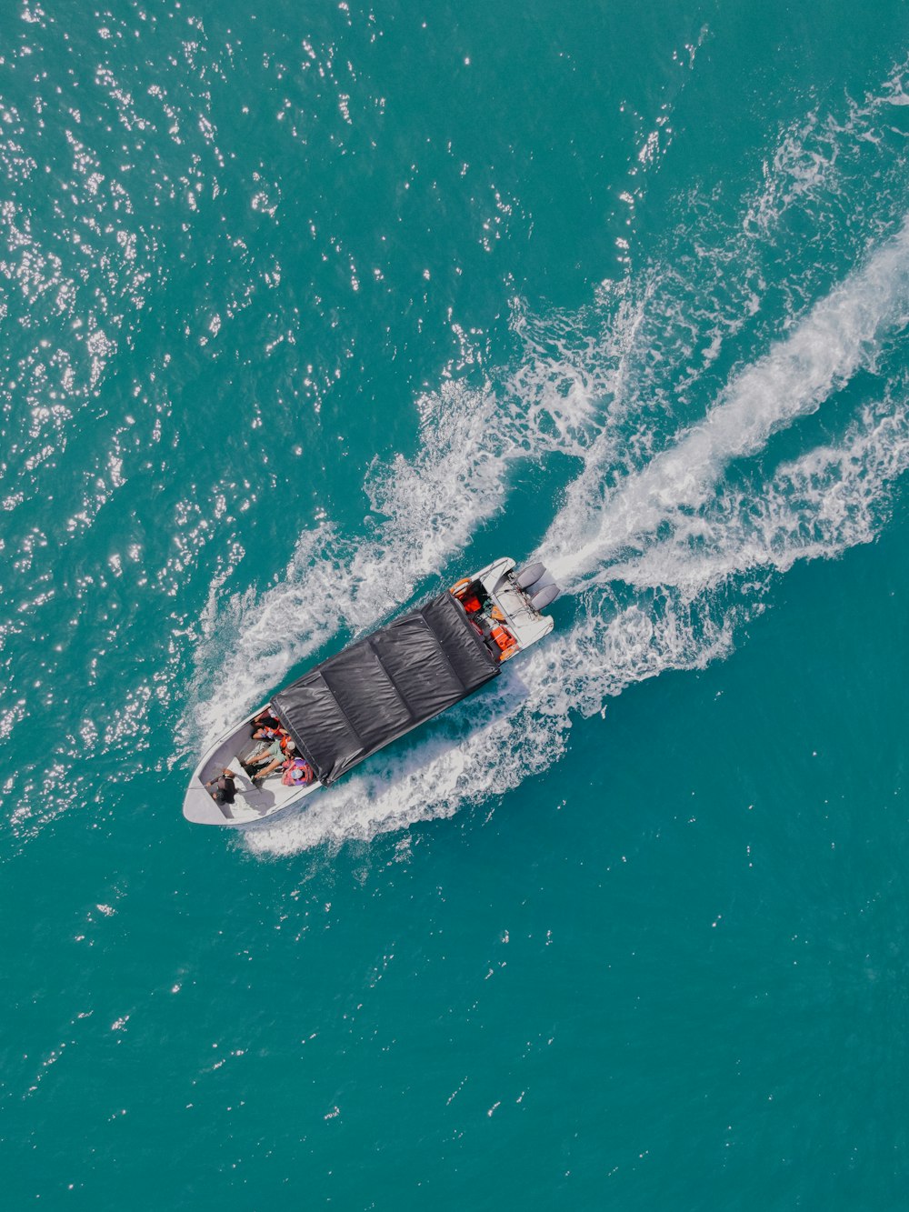 a person riding a boat on top of a body of water